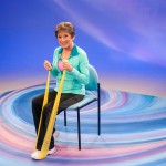 Sit and Be Fit TV host, Mary Ann Wilson RN, practices leg strengthening exercises with a resistance band.