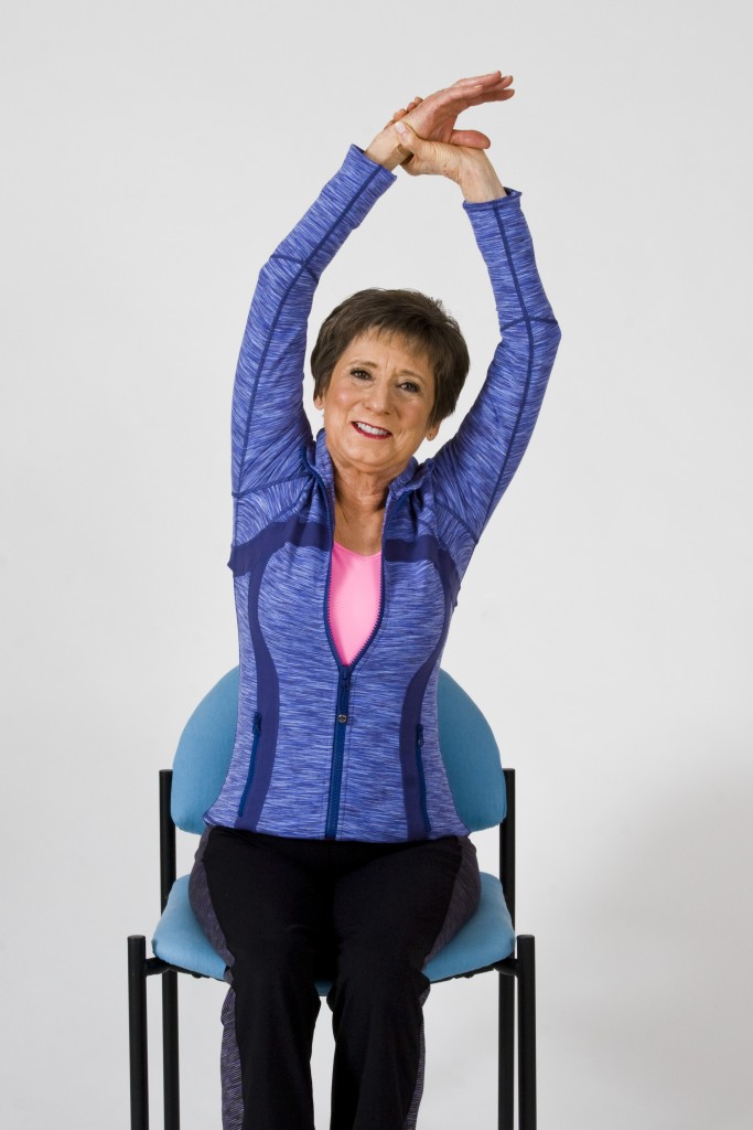 Sit and Be Fit host, Mary Ann Wilson RN, demonstrates a lateral flexion exercise for the spine.