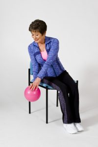 Sit and Be FIt TV host, Mary Ann Wilson, demonstrating a seated exercise for the core.