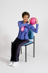 Sit and Be FIt TV host, Mary Ann Wilson, demonstrating a seated exercise for the core.